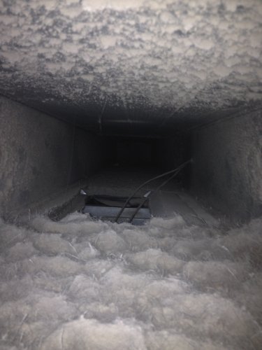 Dust buildup inside duct before cleaning
